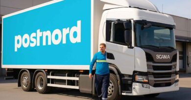 PostNord-chaufför vid lastbil – symbol för stabilt arbete och konkurrenskraftig lön i transportsektorn.